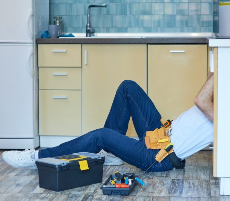 reliable-service-professional-repairman-plumber-examining-and-fixing-sink-pipe-in-the-kitchen.jpg